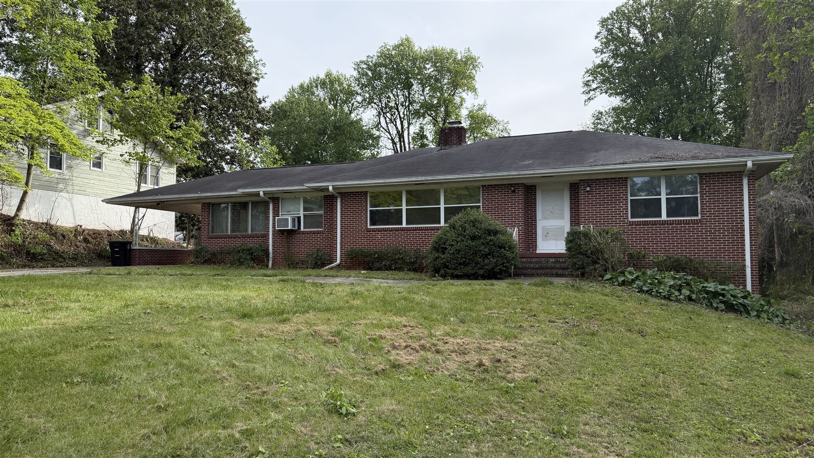 After: same property cleared and mowed, house fully visible