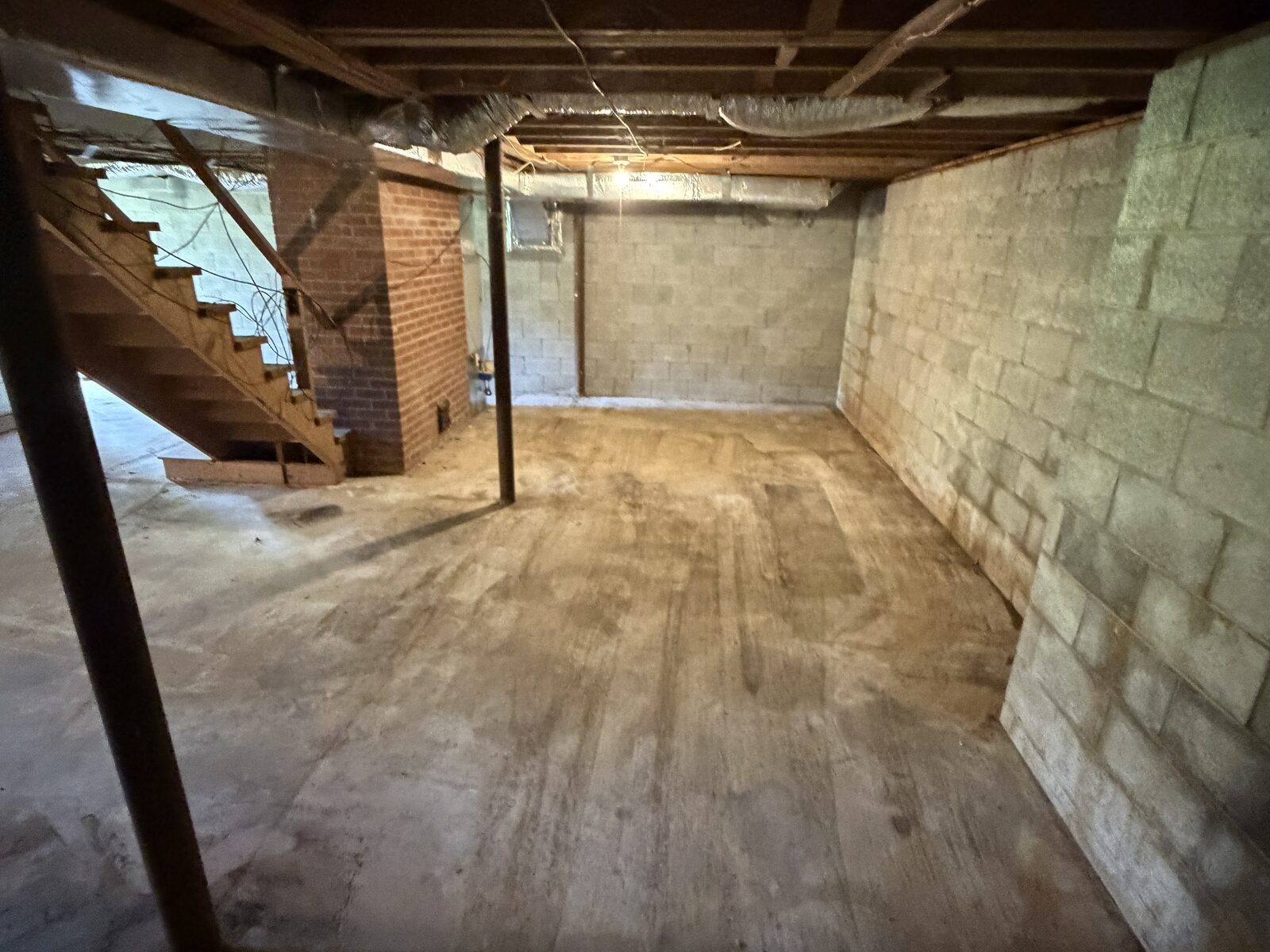 After: the same basement emptied down to bare concrete