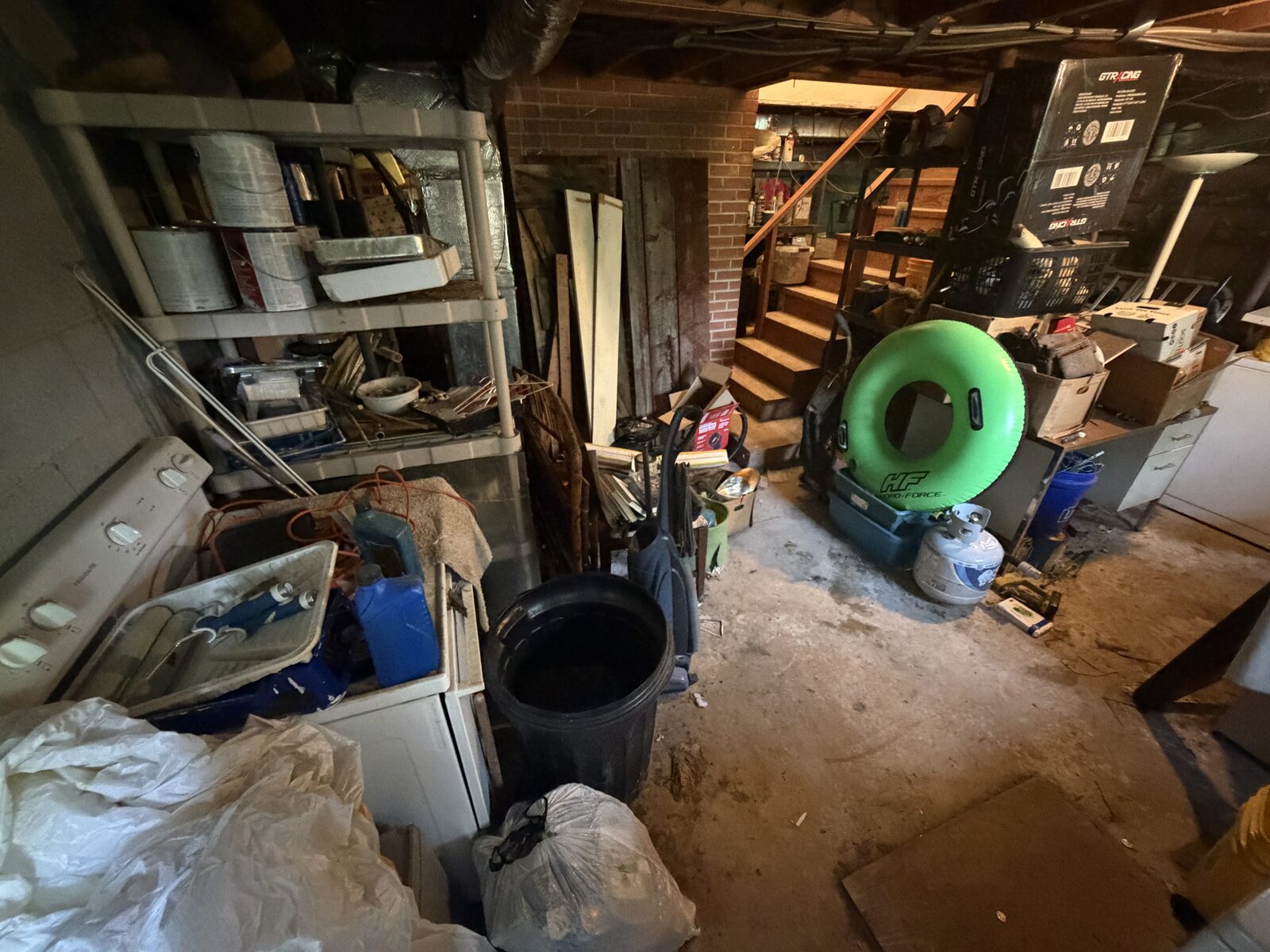 Before: a basement packed floor to ceiling with junk, boxes and bags