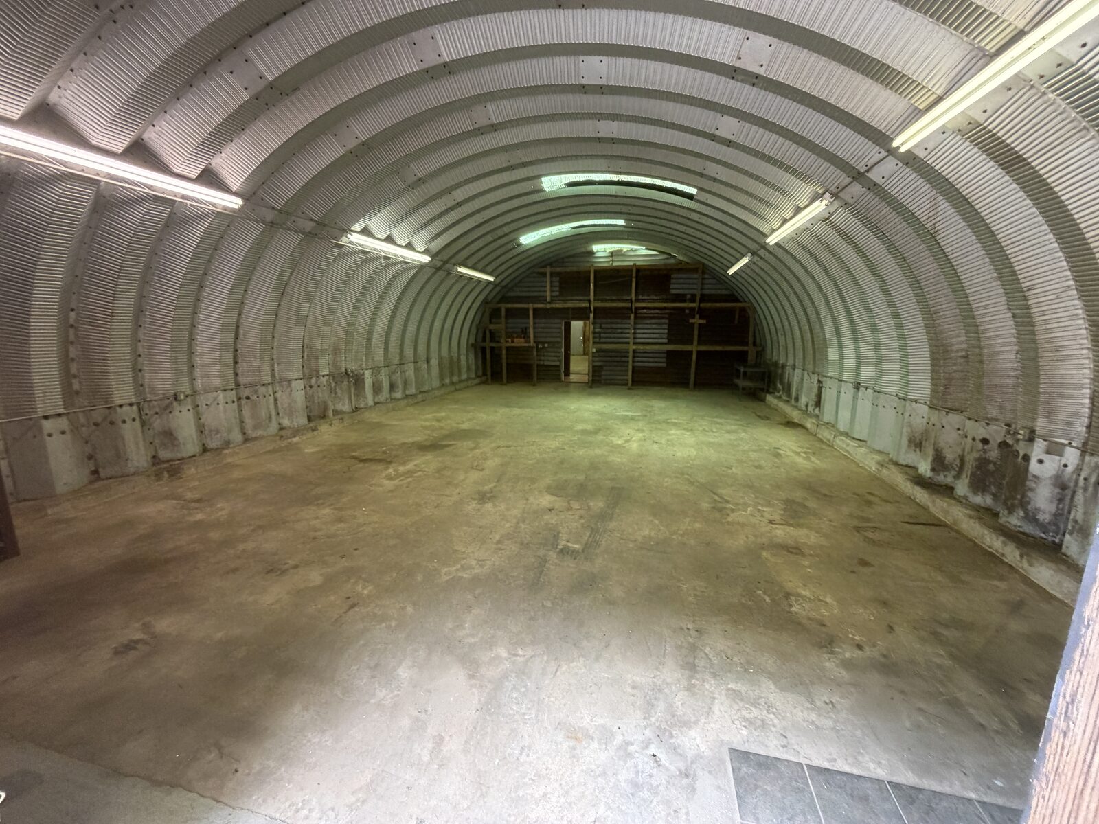 Same workshop building emptied to a clean swept floor